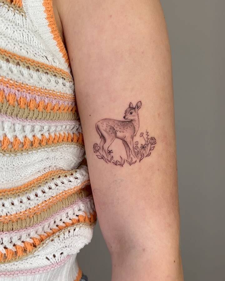 Fawn tattoo in illustrative style done on the upper arm.