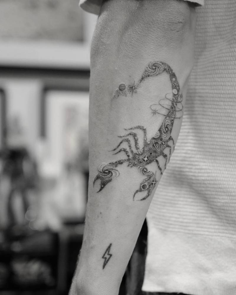 Single needle space scorpion tattoo located on the forearm.