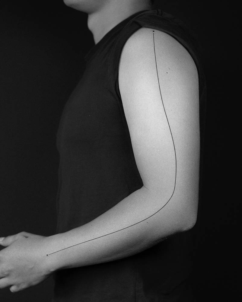 Minimalistic style line tattoo located on the arm.
