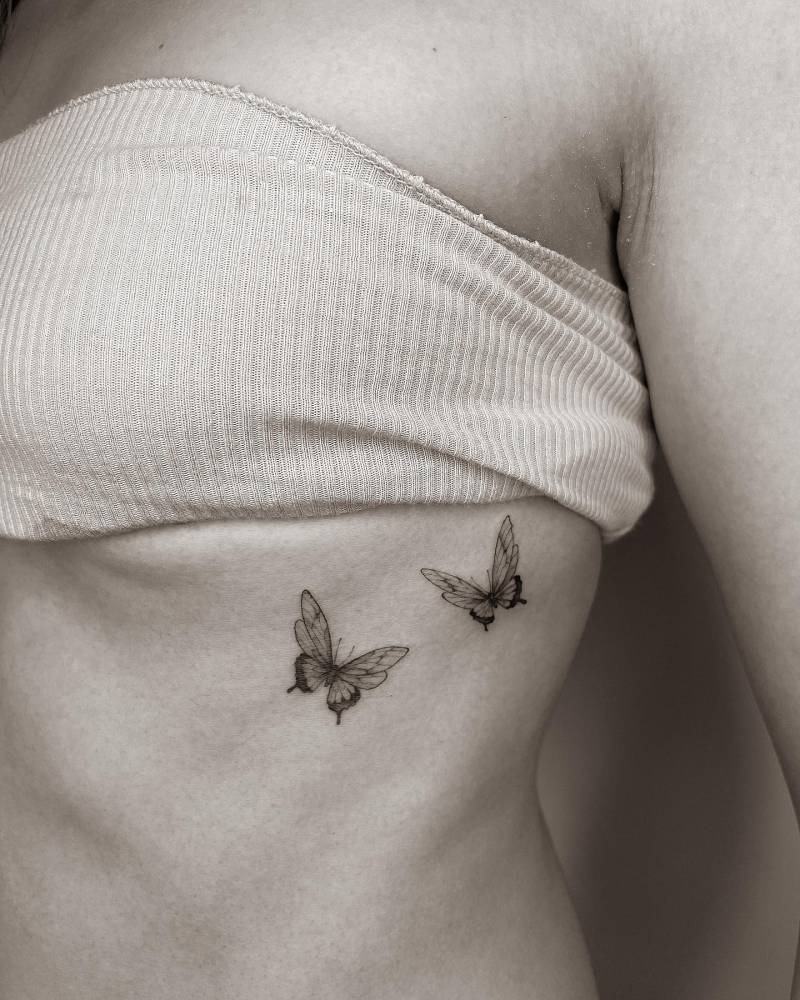 Butterfly couple tattoo done on the rib, illustrative style.