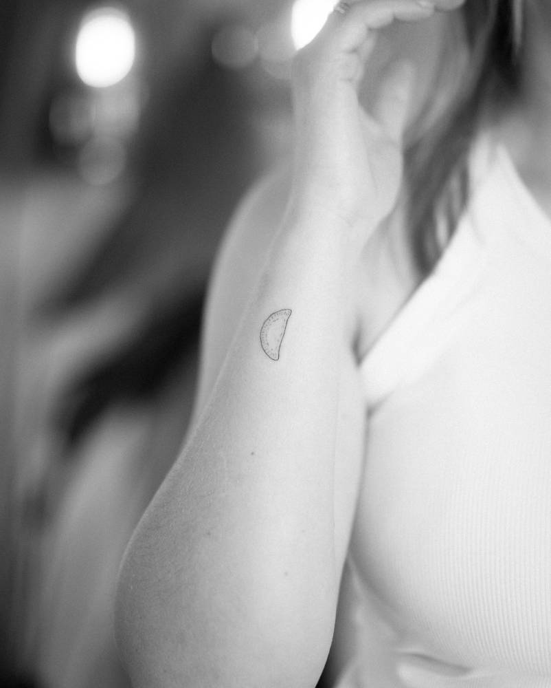 Dumpling tattoo located on the wrist, fine line style.