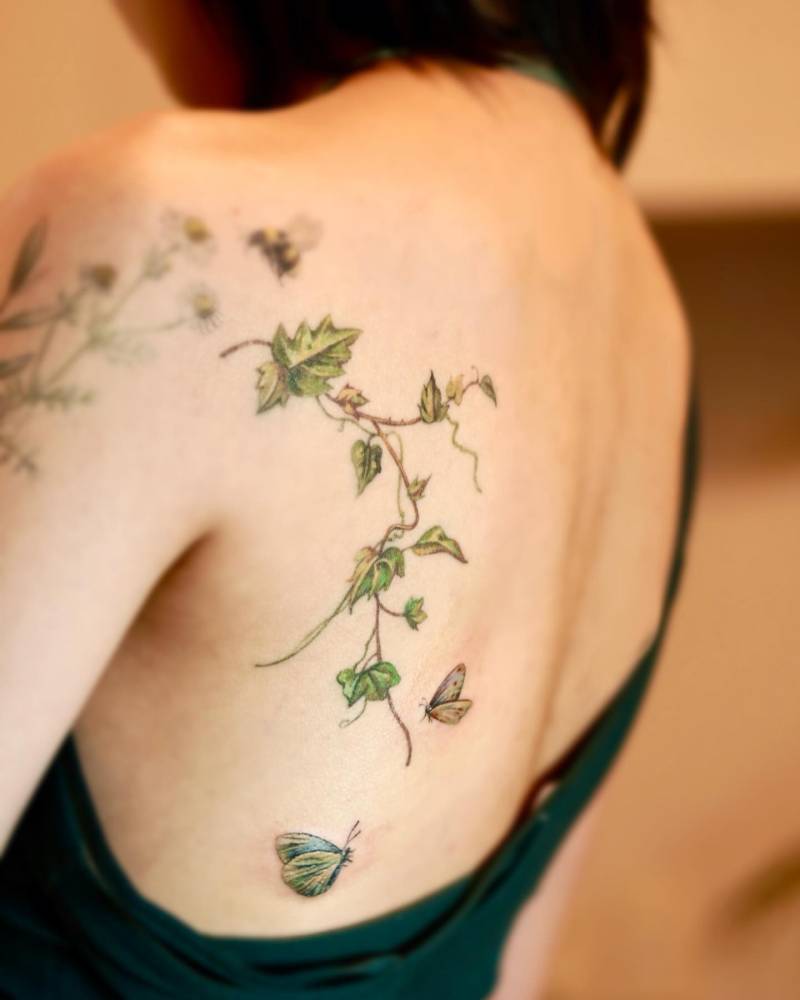 Healed ivy and fresh butterfly couple tattoo located on the back.
