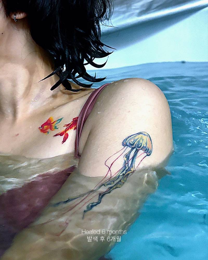 6 months healed jellyfish tattoo located on the upper arm.