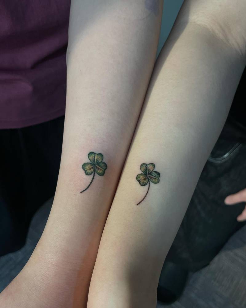 Matching three leaf clover tattoo for couple.