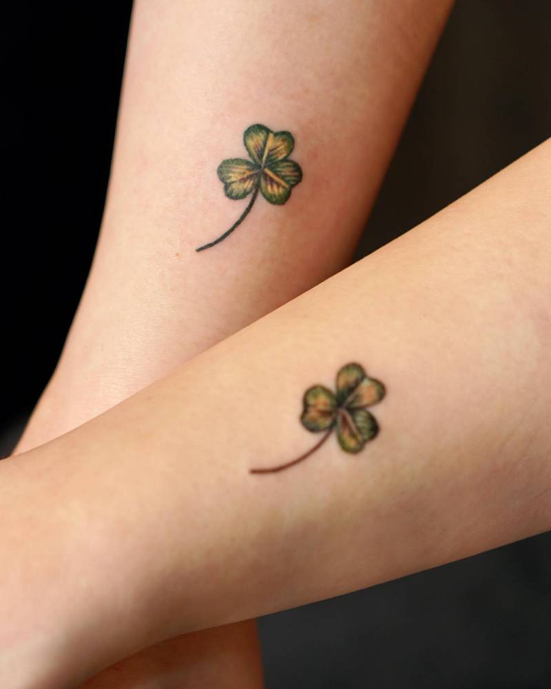 Matching three leaf clover tattoo for couple.