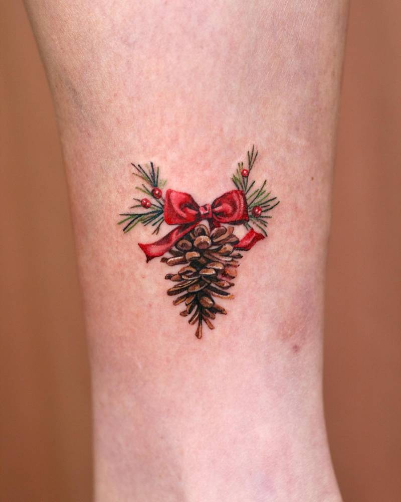 Watercolor style pine cone tattoo done on the ankle.