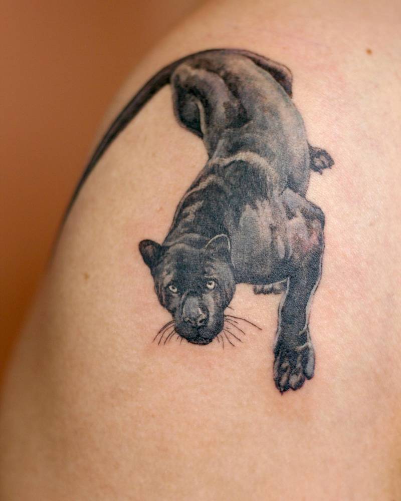 Black panther tattoo placed on the shoulder, watercolor style.