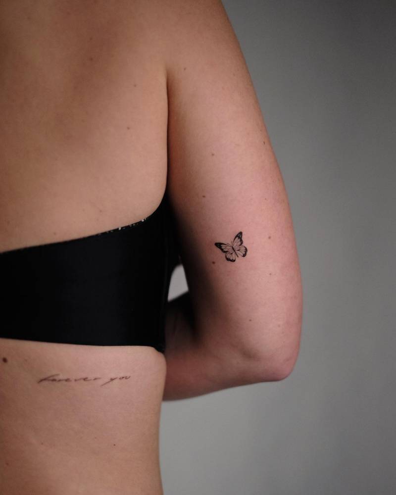 Illustrative style butterfly tattoo placed on the inner arm.