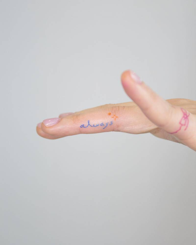 Lettering tattoo of the word "always" located on the finger.