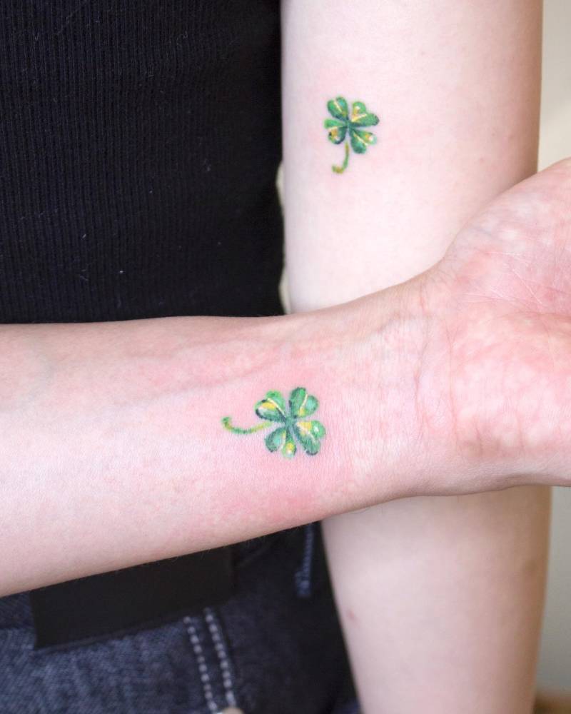 Matching four leaf clover tattoo for couple, watercolor style.