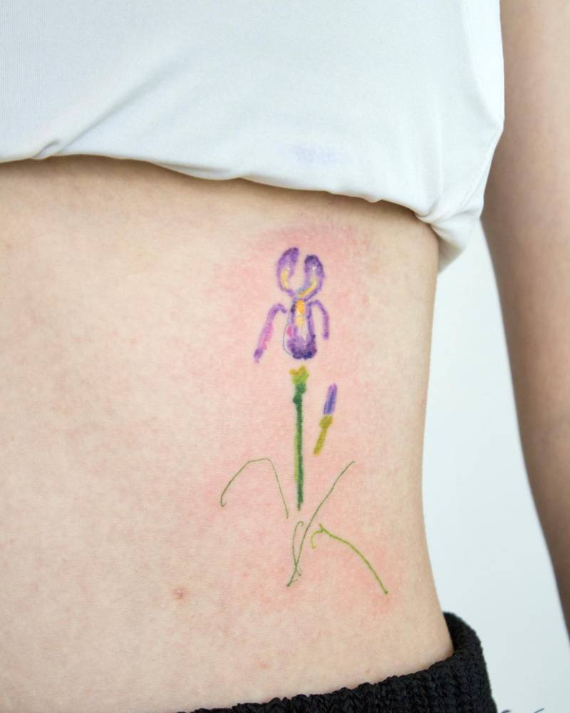Iris flower tattoo placed on the rib, watercolor style.