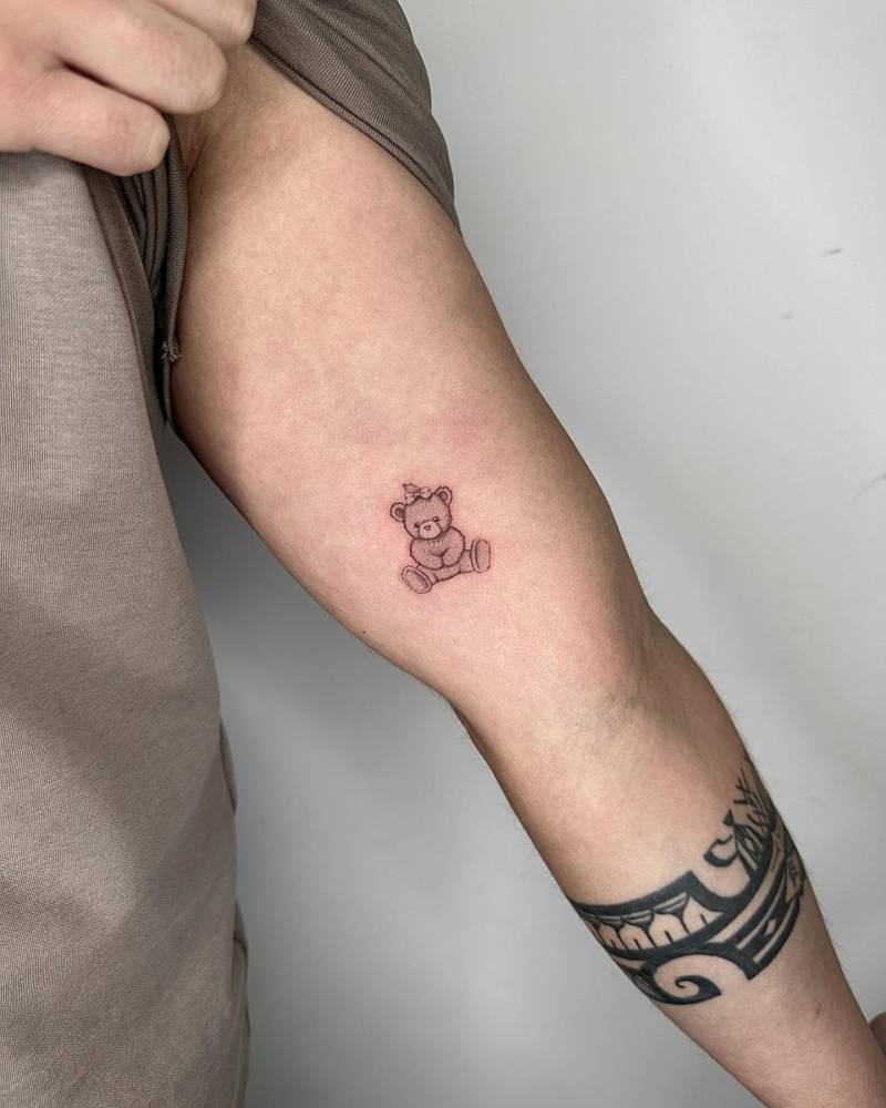 Illustrative style teddy bear tattoo located on the inner arm.