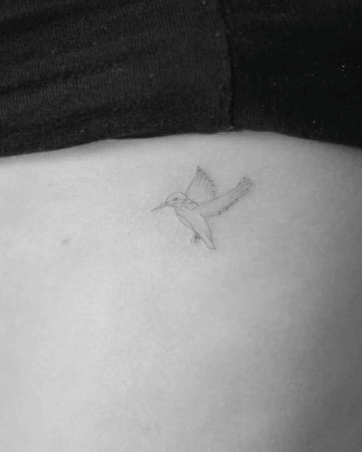 Little hummingbird tattoo located on the rib.