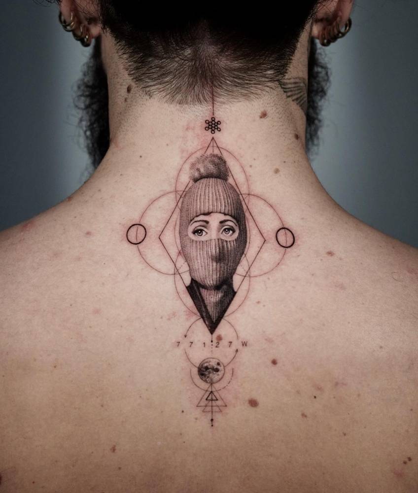 'Fornasetti Tema e Variazoni 160' tattooed on the upper back.