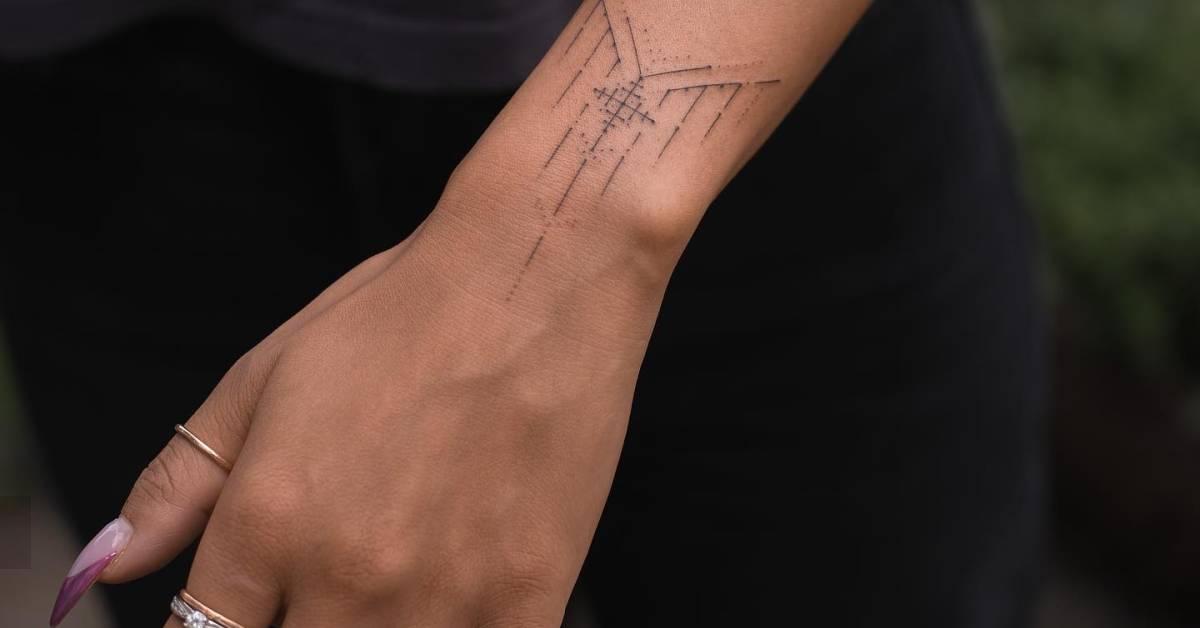 Hand poked ornament tattooed on the wrist.
