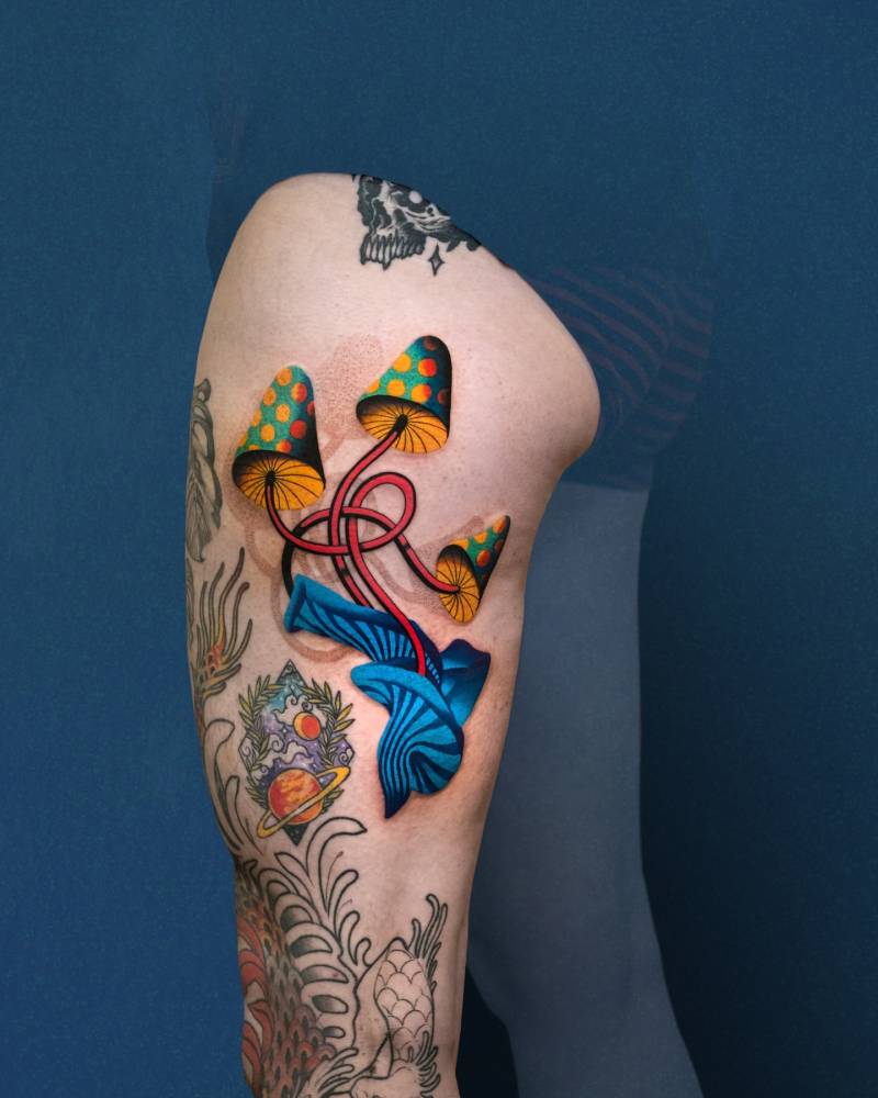 Mushrooms tattoo in pop art style done on the thigh.