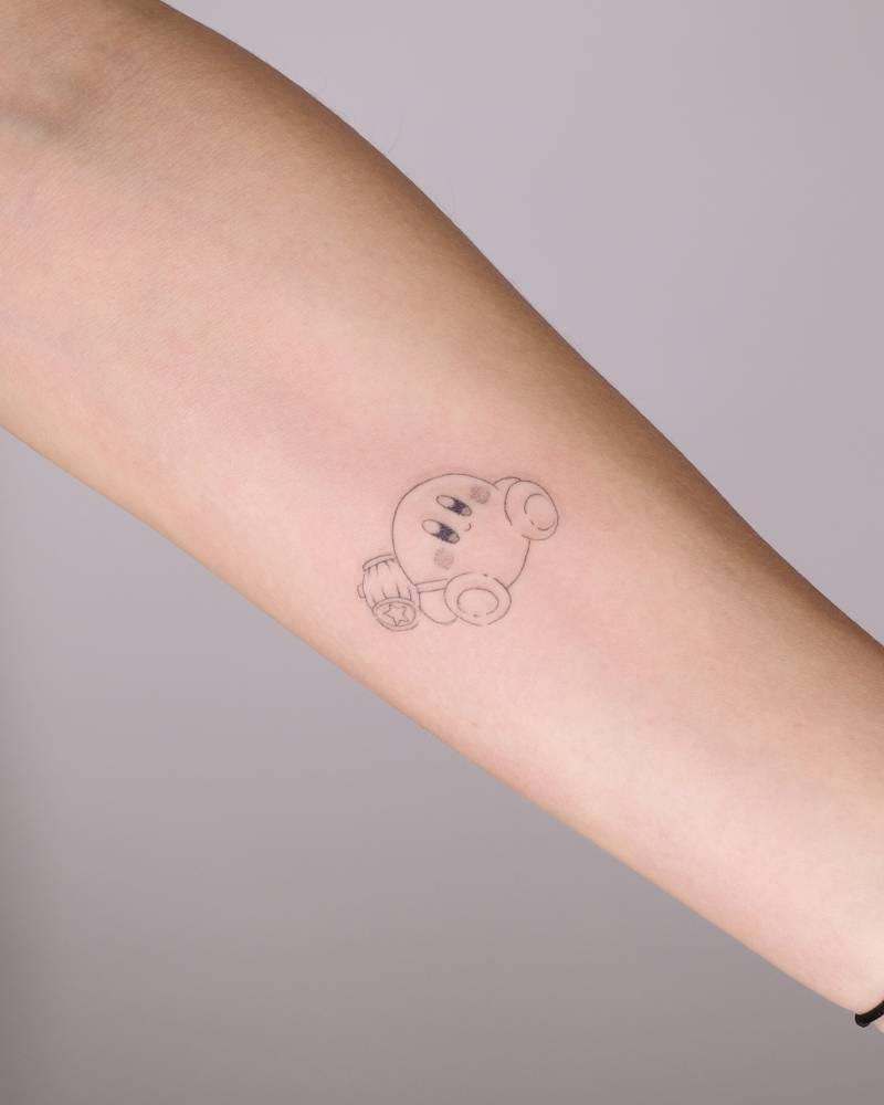 Cartoon style Kirby tattoo placed on the inner forearm.