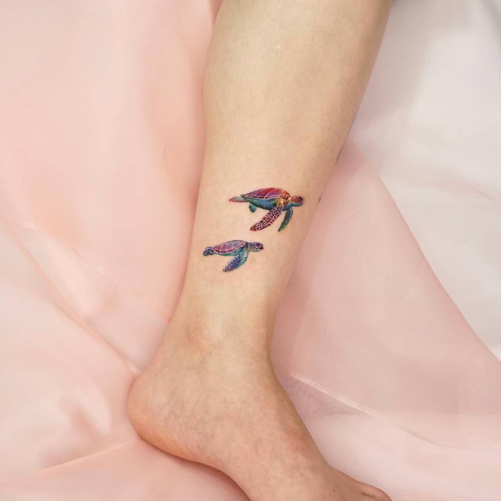 Sea turtles tattoo in micro-realistic style located on the shin.