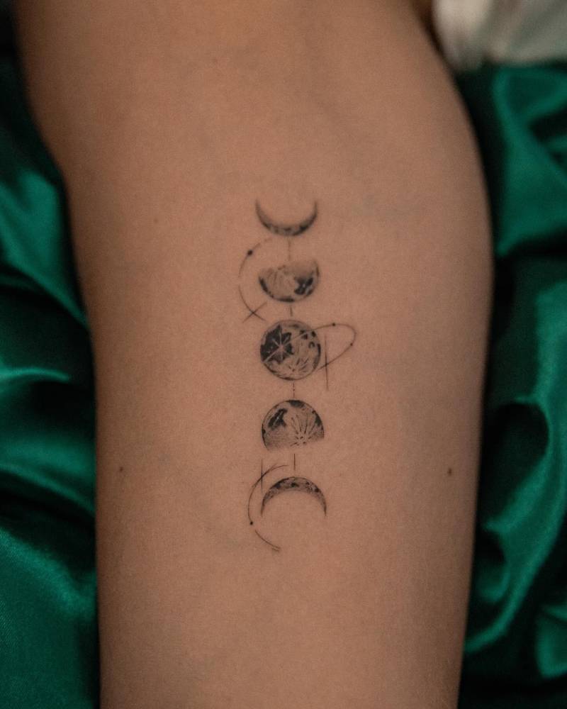 Micro-realistic style moon phases tattoo placed on the inner arm.