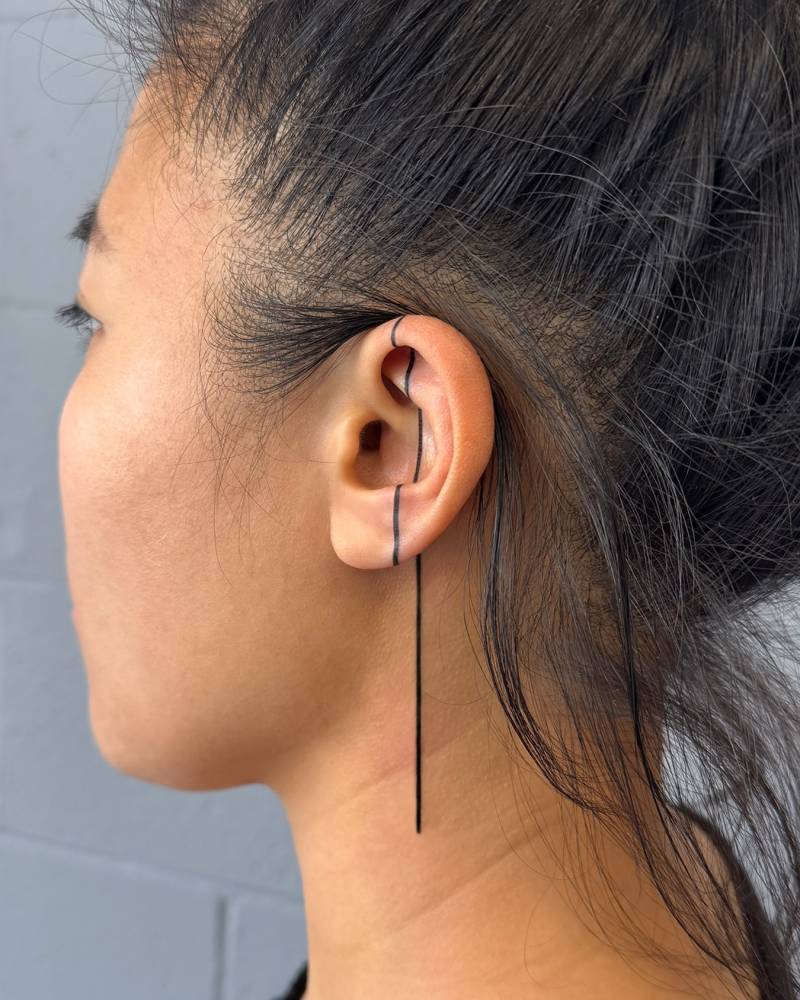 Line tattoo located on the ear and neck, geometric style.