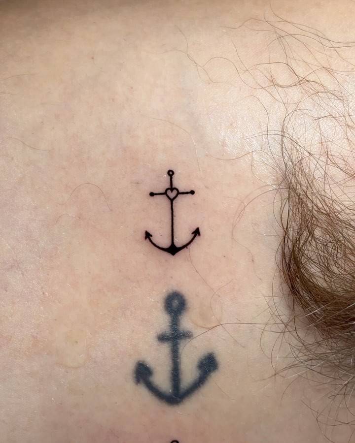 Tiny minimalistic anchor tattoo located on the inner arm.