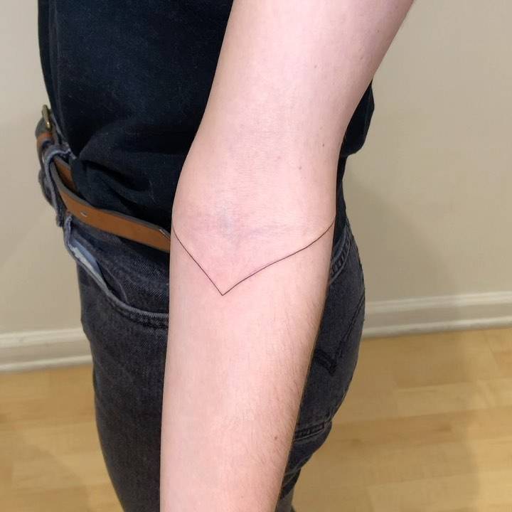 Line tattoo on the inner forearm.