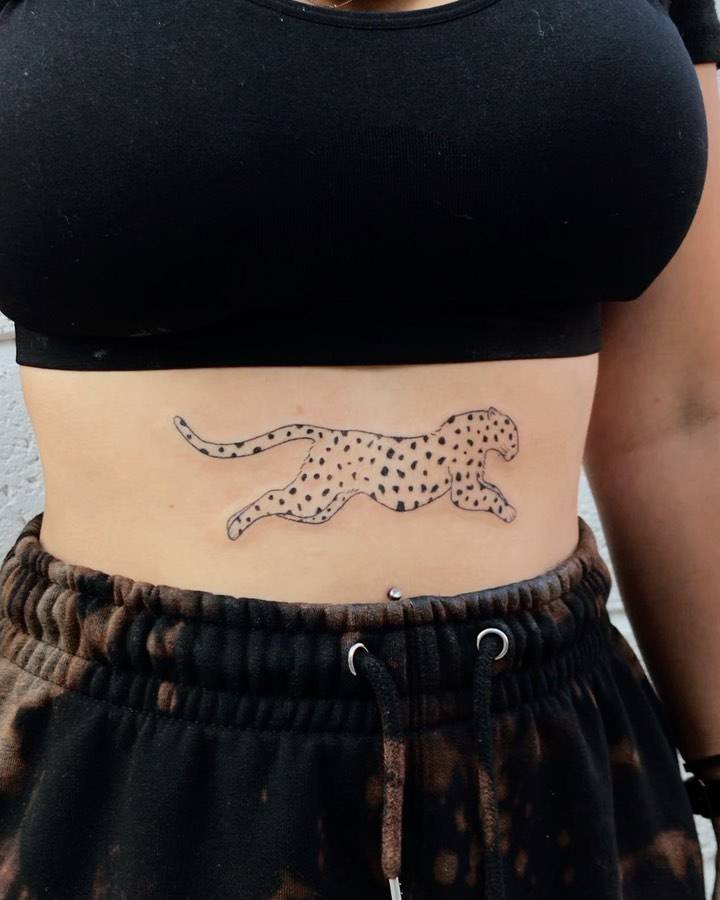 Cheetah tattoo hand poked on the stomach.