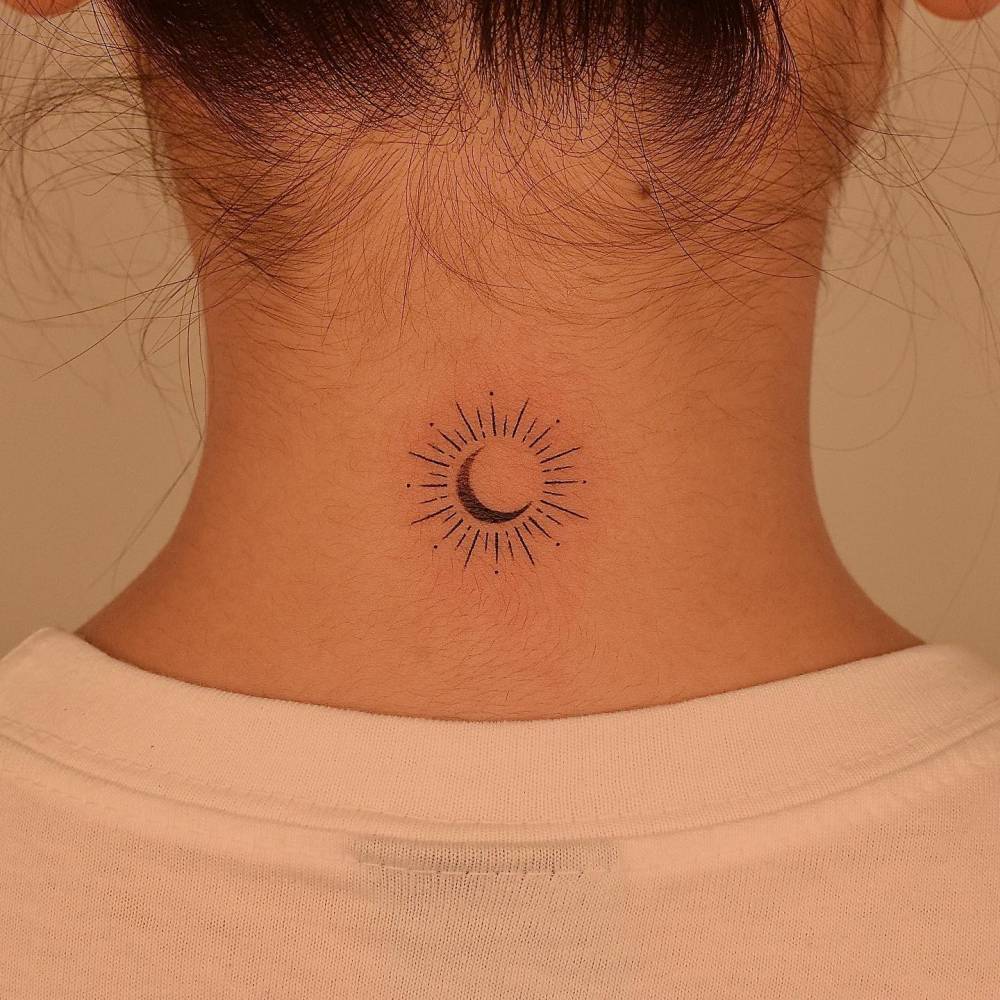 Sun and Moon ornament tattoo located on the back of the neck.