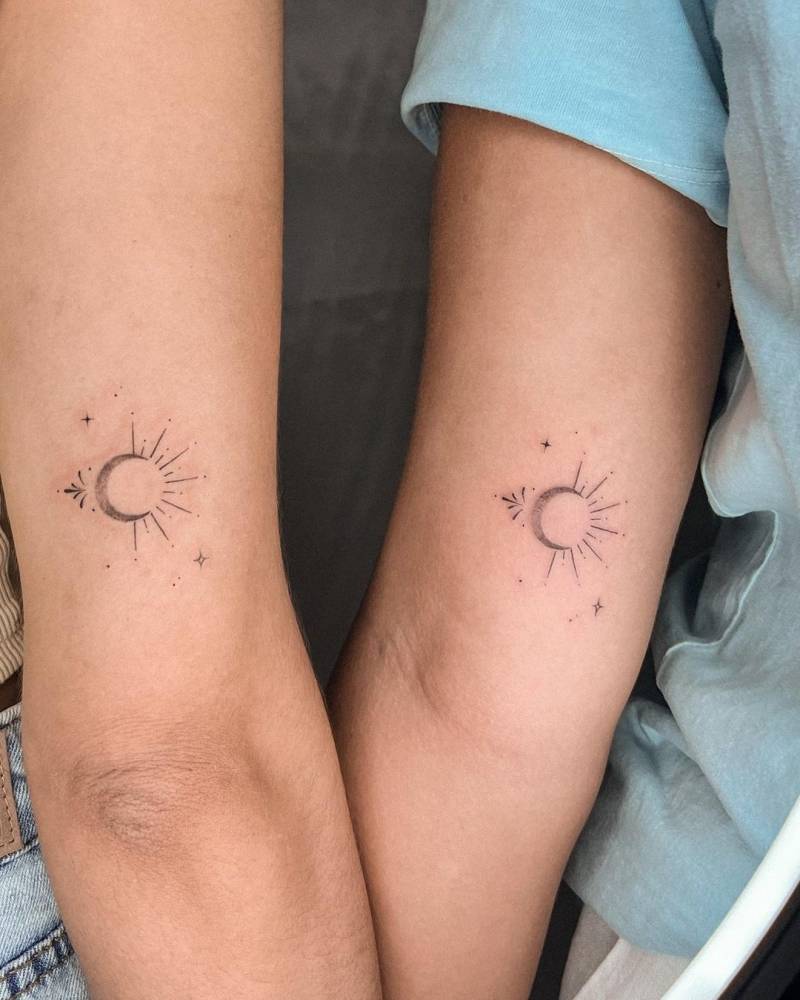 Fine line matching sun and moon tattoo for sisters.