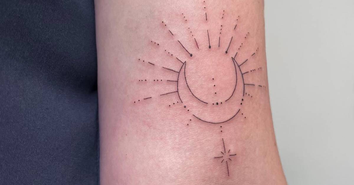 Fine line style sun and moon tattoo done on the bicep.