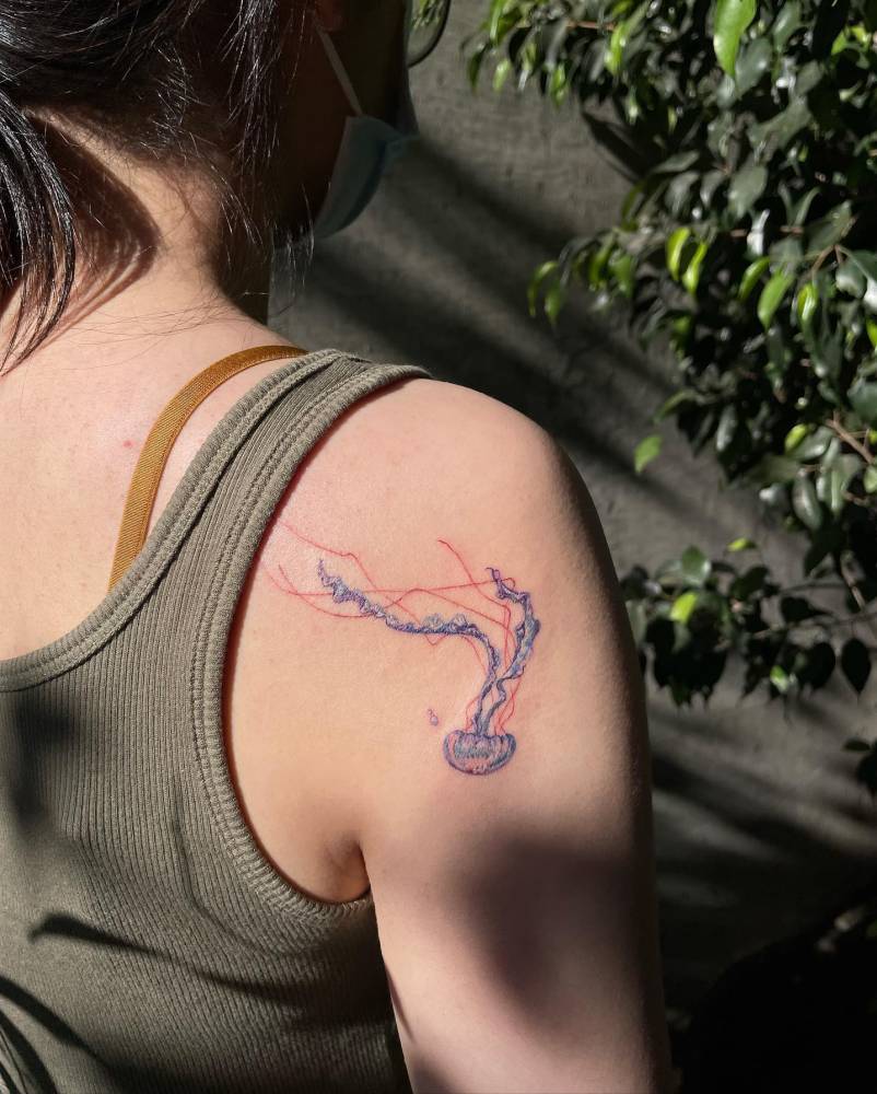 Watercolor jellyfish tattoo done on the shoulder blade.