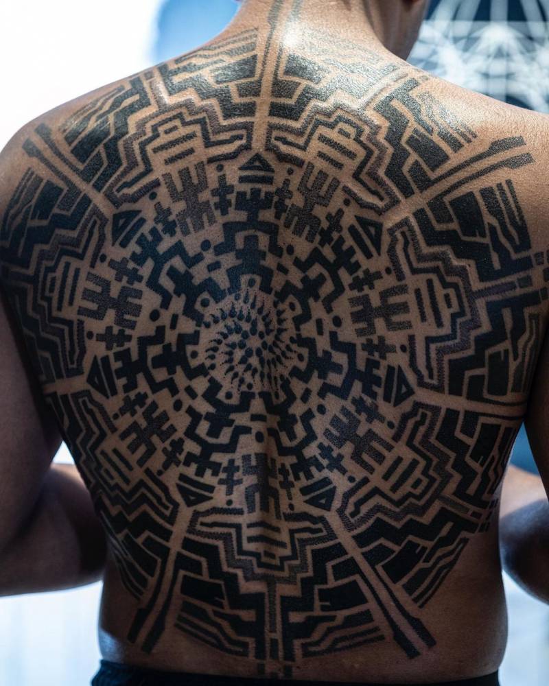 Sacred geometry backpiece tattoo.