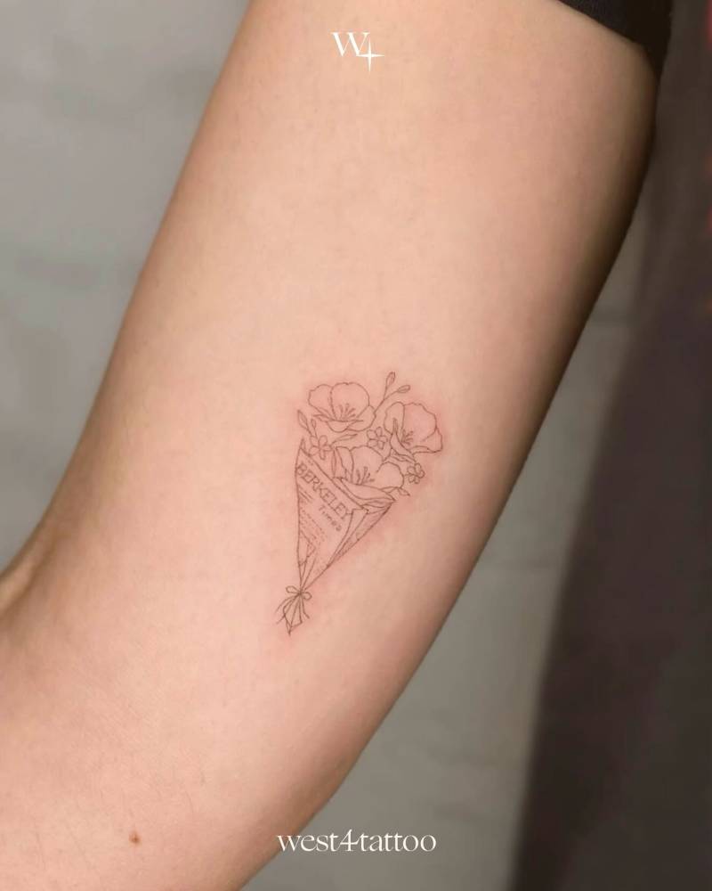 Flower bouquet tattoo placed on the inner arm, fine line style.