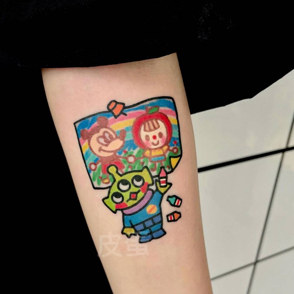 Toy Story Alien tattoo located on the inner forearm, cartoon style.