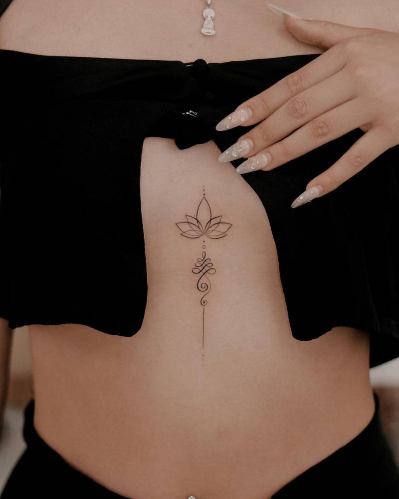 Fine line lotus unalome tattoo done on the sternum.
