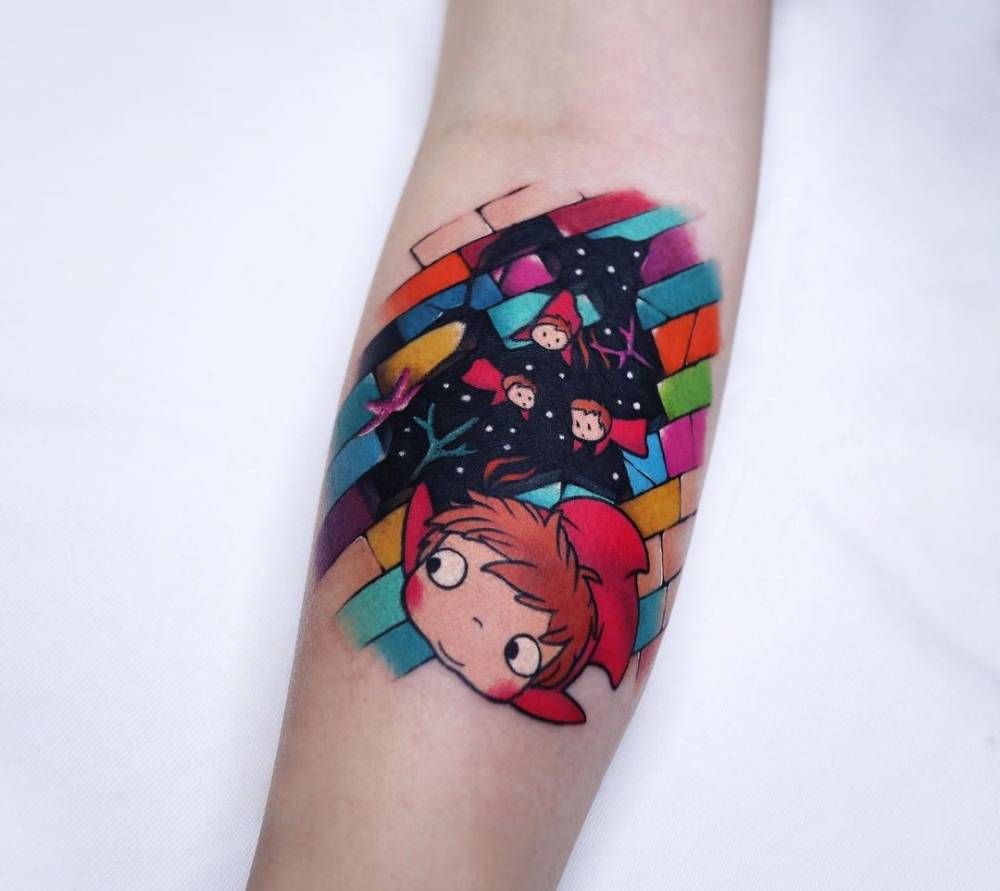Ponyo tattoo located on the inner forearm, cartoon style.