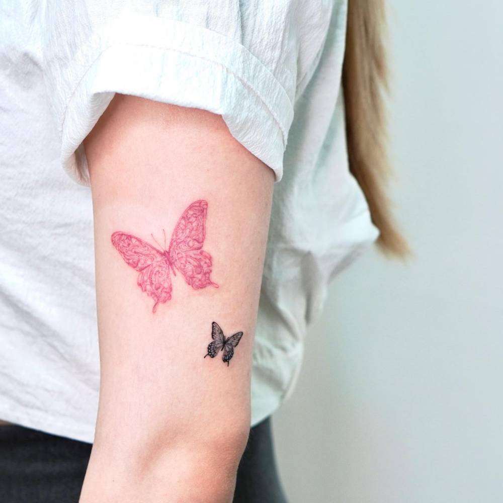 Butterfly couple tattoo located on the upper arm.