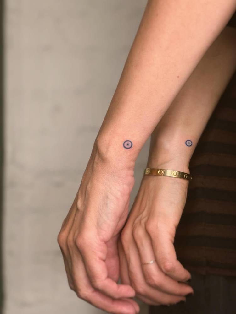 Matching minimalistic Nazar tattoo for best friends.