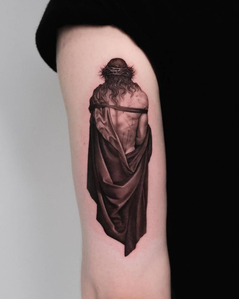 Jesus tattoo located on the tricep, done in micro-realistic style.