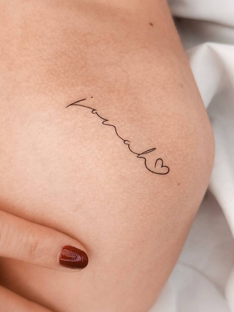 Handwritten font name "Jonah" tattoo located on the shoulder.