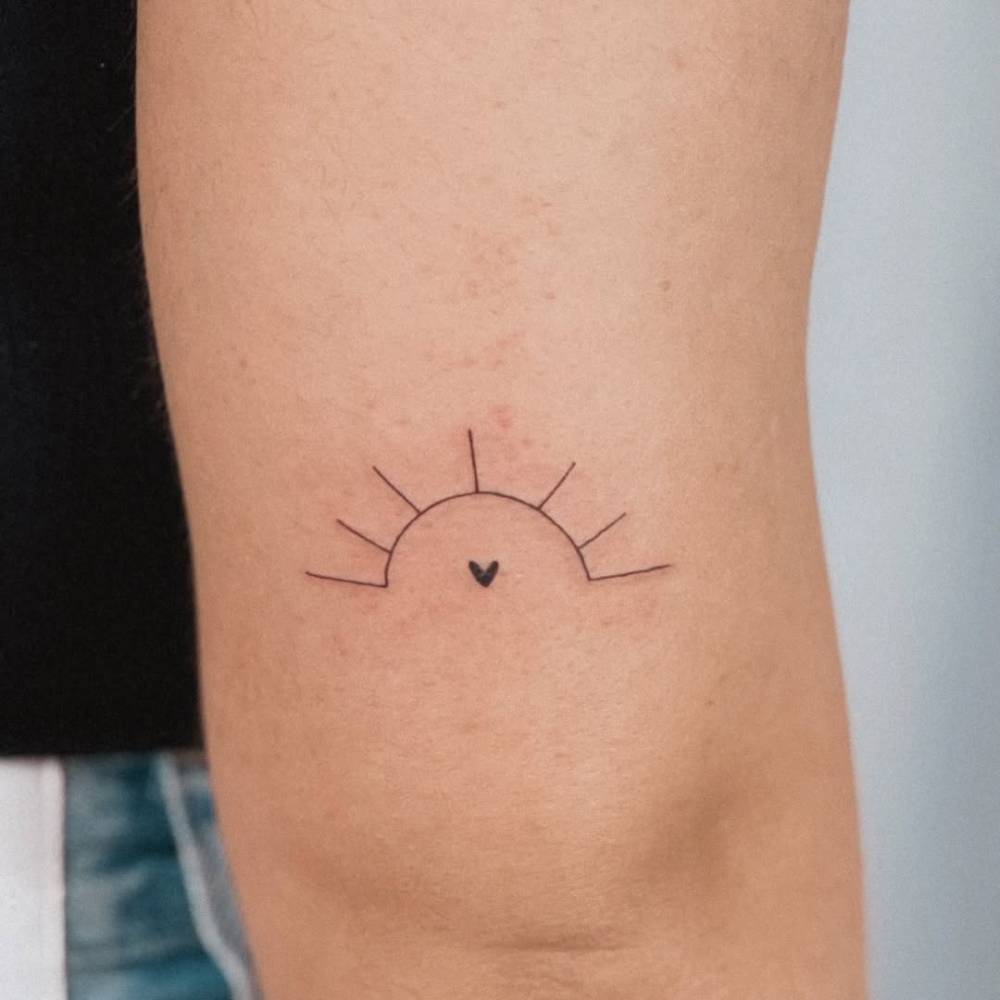 Minimalistic style sunset and heart tattoo located on the tricep.