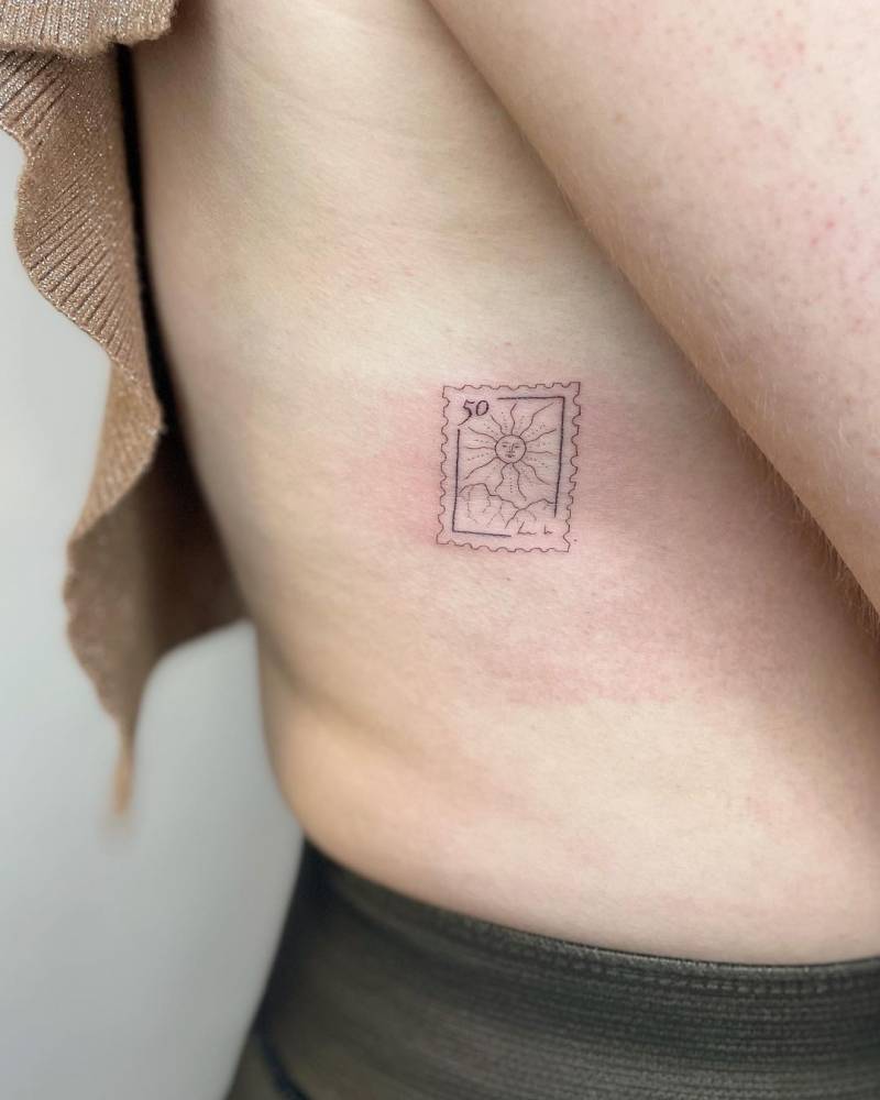 Sun stamp tattoo located on the rib, fine line style.