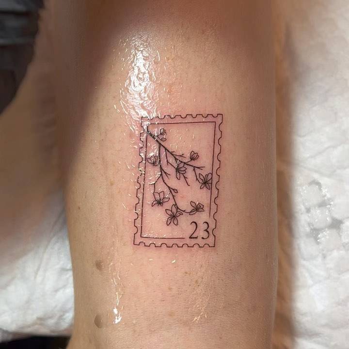 Branch stamp tattoo located on the tricep.