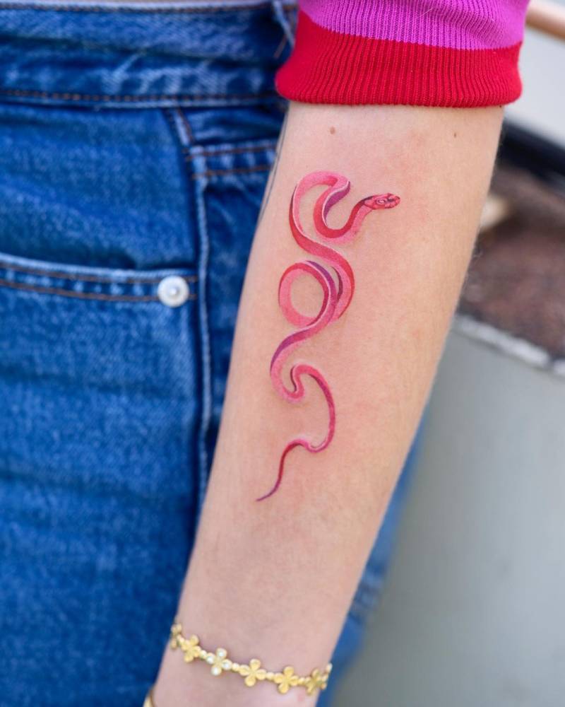 Pink snake tattoo done on the forearm.