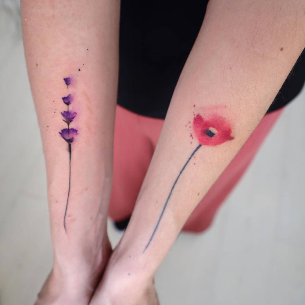 Lavender and poppy tattoos located on the forearm.