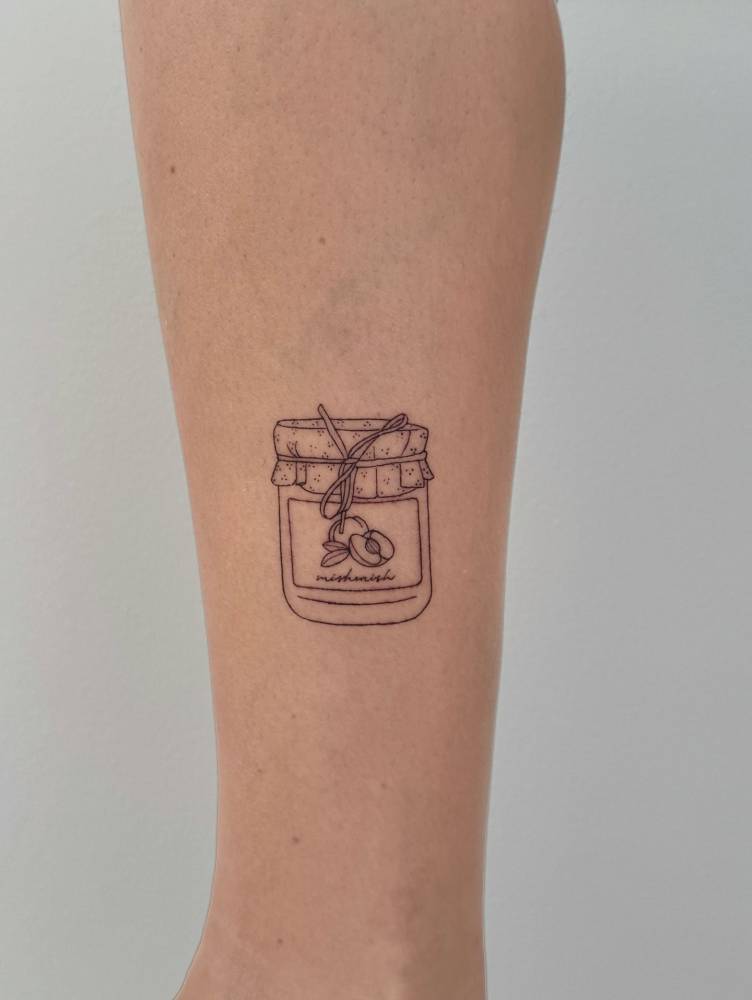 Peach jam tattoo located on the shin, fine line style.