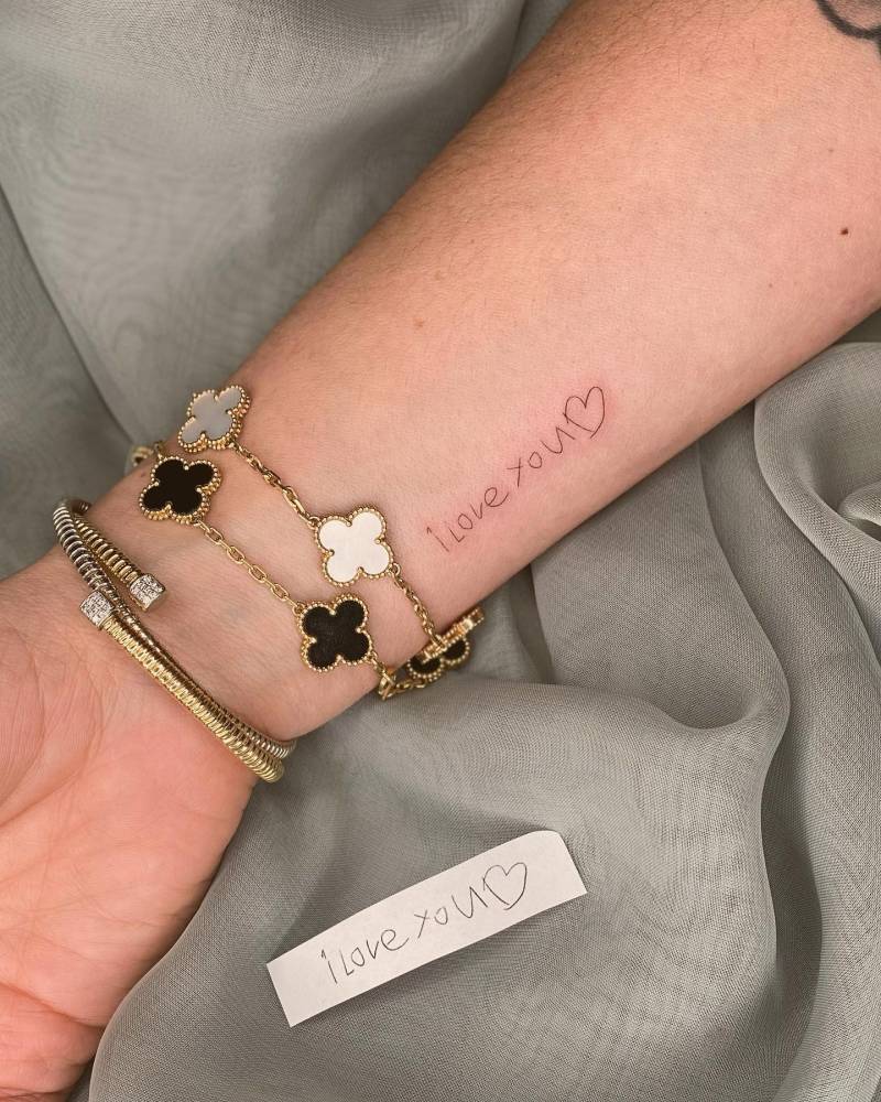 Daughter's handwriting "I love you" tattooed on the wrist.