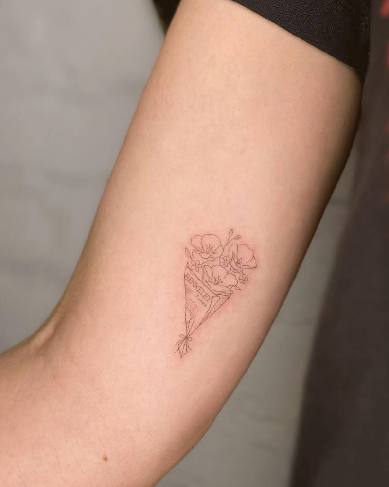Flower bouquet in fine line style tattooed on the inner arm.