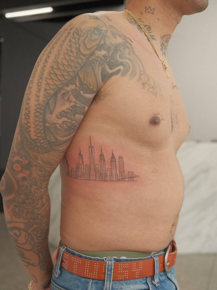 New York City skyline tattoo located on the rib.