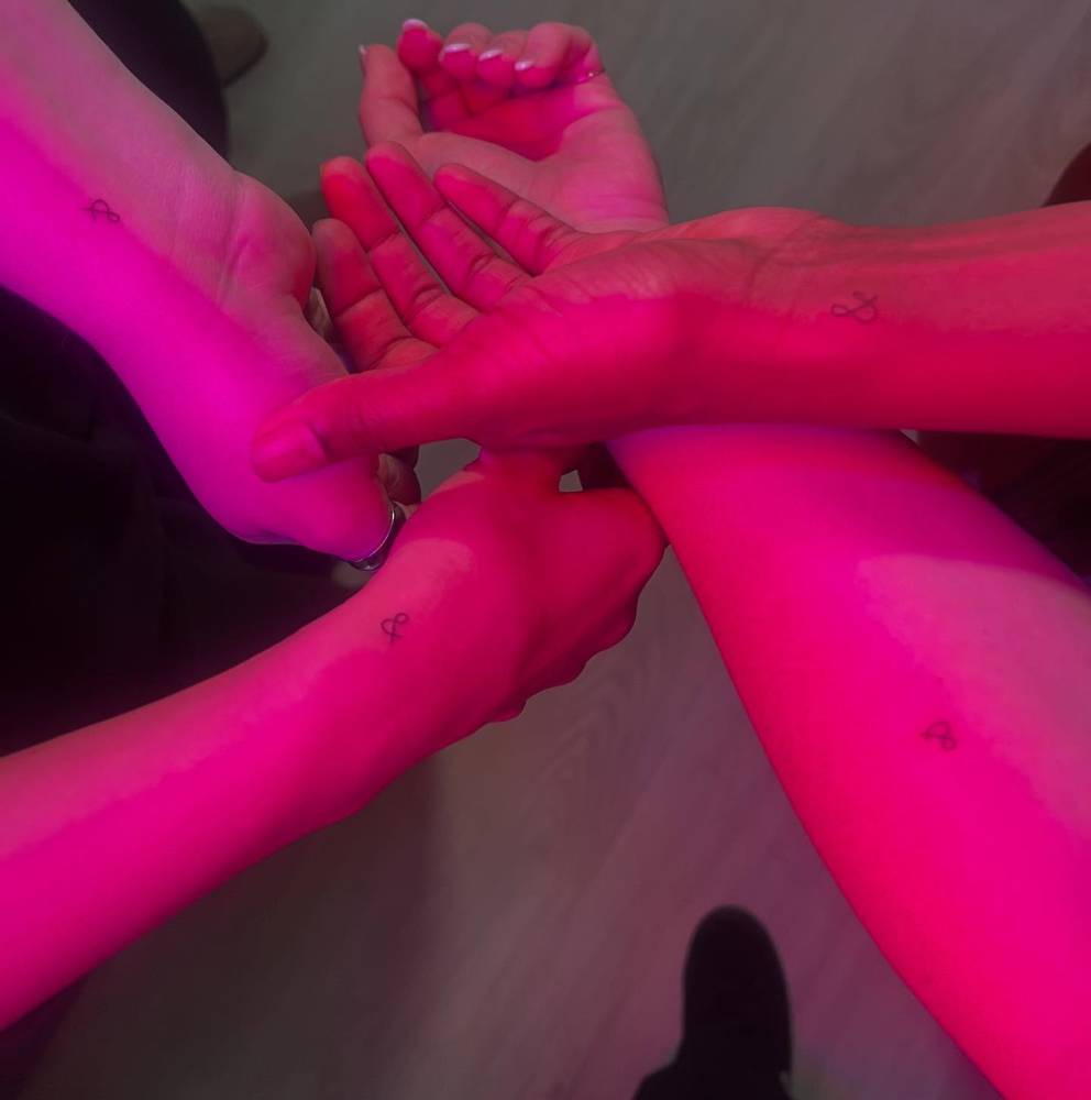 Matching ampersand tattoo for best friends, minimalistic style.